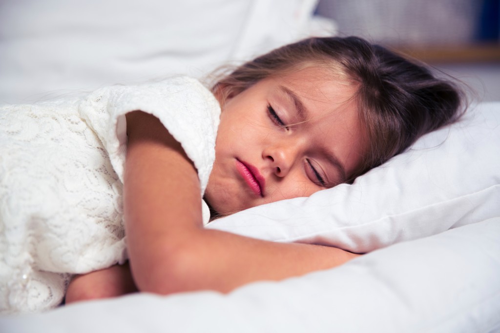 Little girl resting in bed