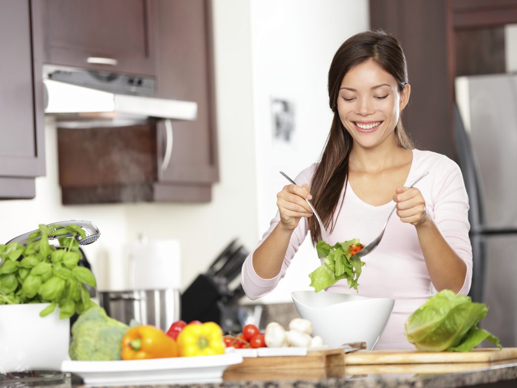 Woman making salad