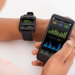 Close-up Of Hand With Mobile And Smartwatch Showing Heartbeat Rate