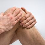 Man suffering from knee pain.