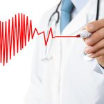 Male doctor drawing heart symbol