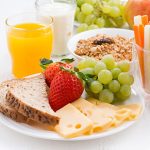 healthy and nutritious breakfast with fresh fruits and vegetables on white table, close-up, horizontal